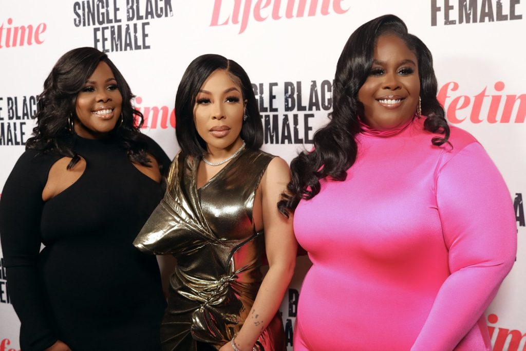 visual storytelling for brand transformation. Cast members from "Single Black Female" posing on the red carpet in elegant outfits at a Lifetime event, including one woman in a metallic gold dress and another in bright pink.